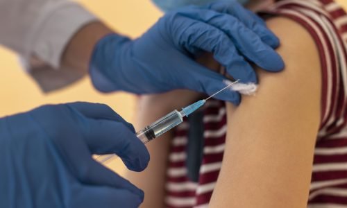 close-up-kid-with-face-mask-getting-vaccine